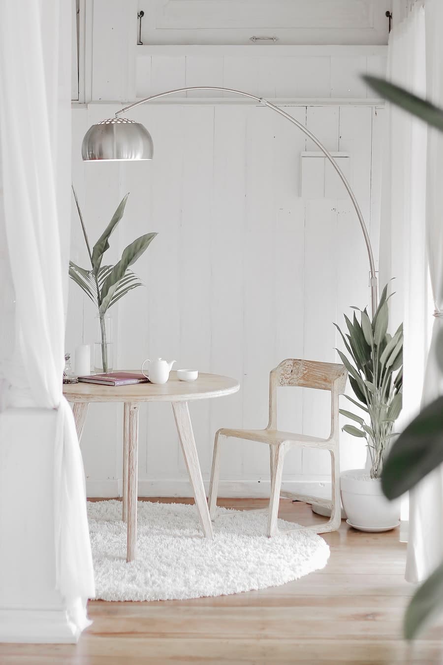 Quiet white corner with soft textures and greenery